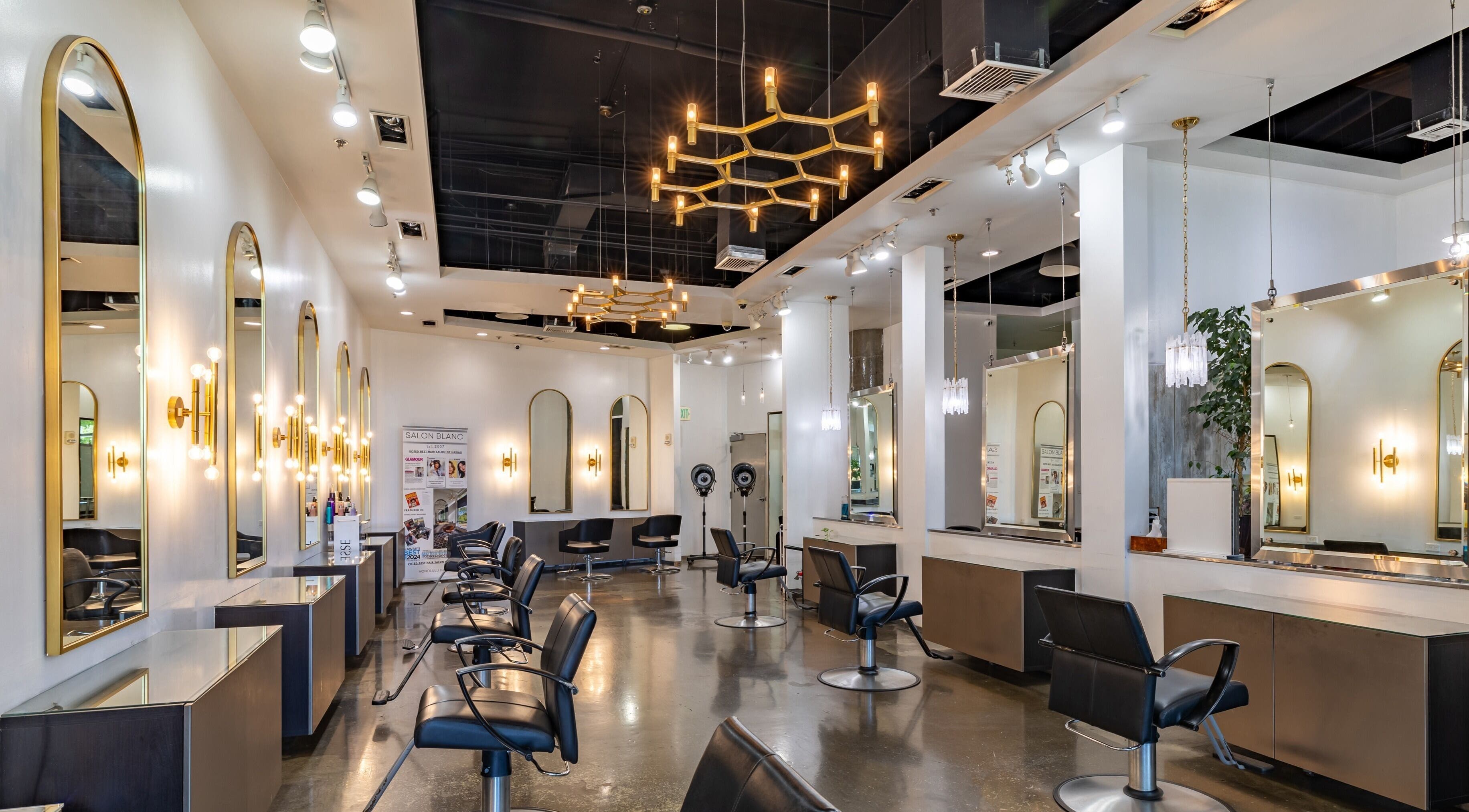 Chic interior of Salon Blanc the celebrities salon in Honolulu, Hawaii, US with stylish mirrors and lighting.