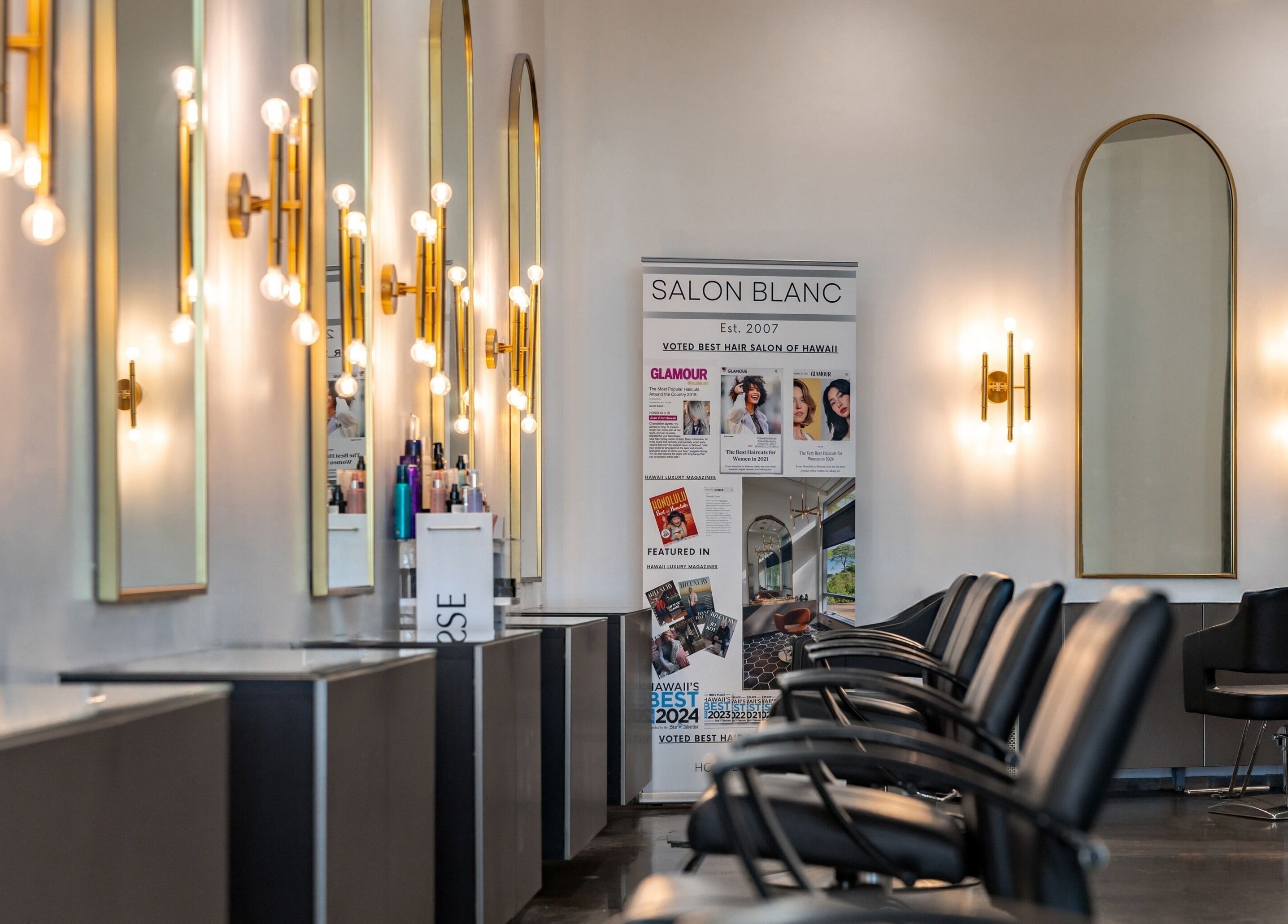 Elegant interior of Salon Blanc the celebrities salon in Honolulu, Hawaii, US featuring stylish mirrors and seating.