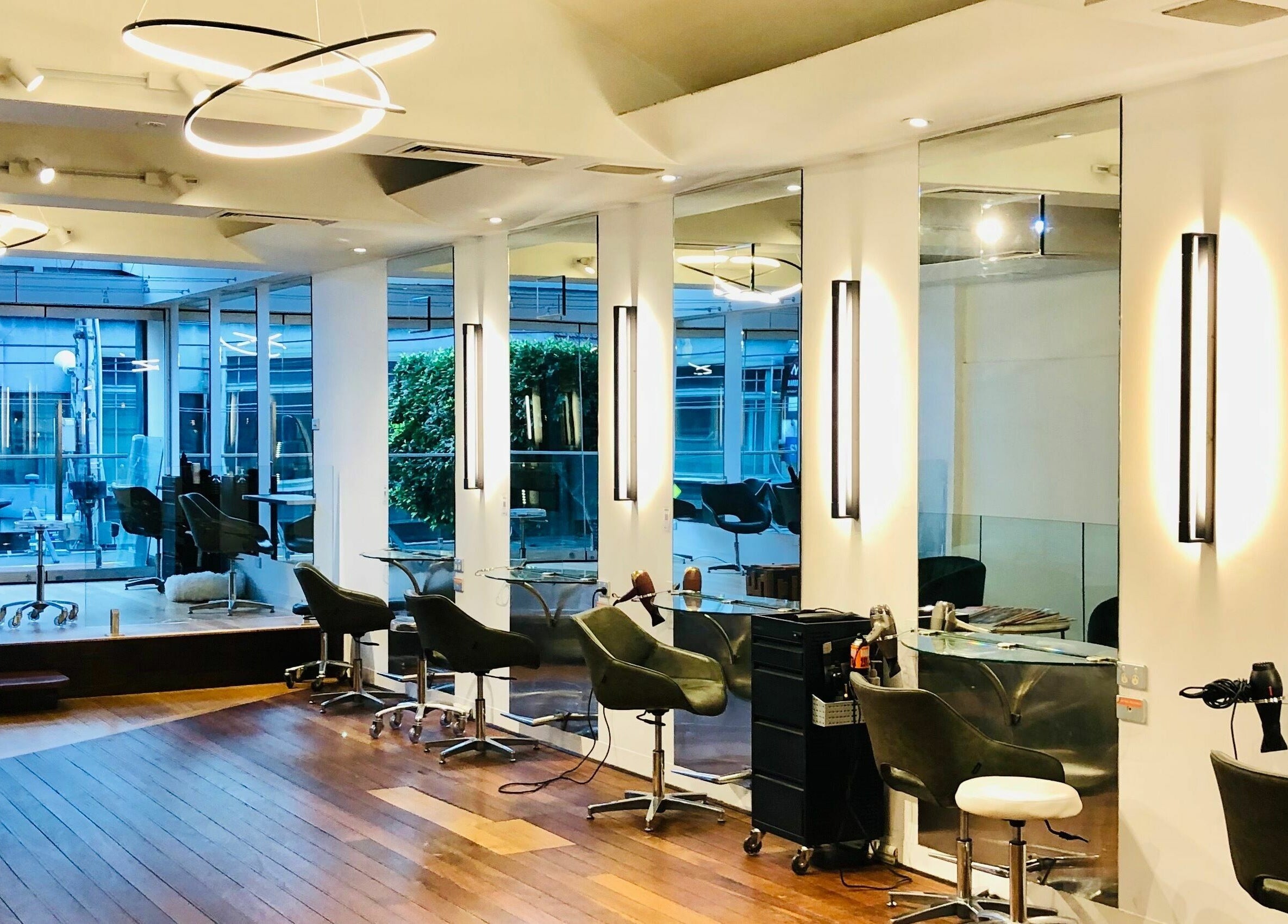 Sophisticated interior of Prodigal Hairdressing in Toorak, Victoria, AU with stylish seating and modern lighting.