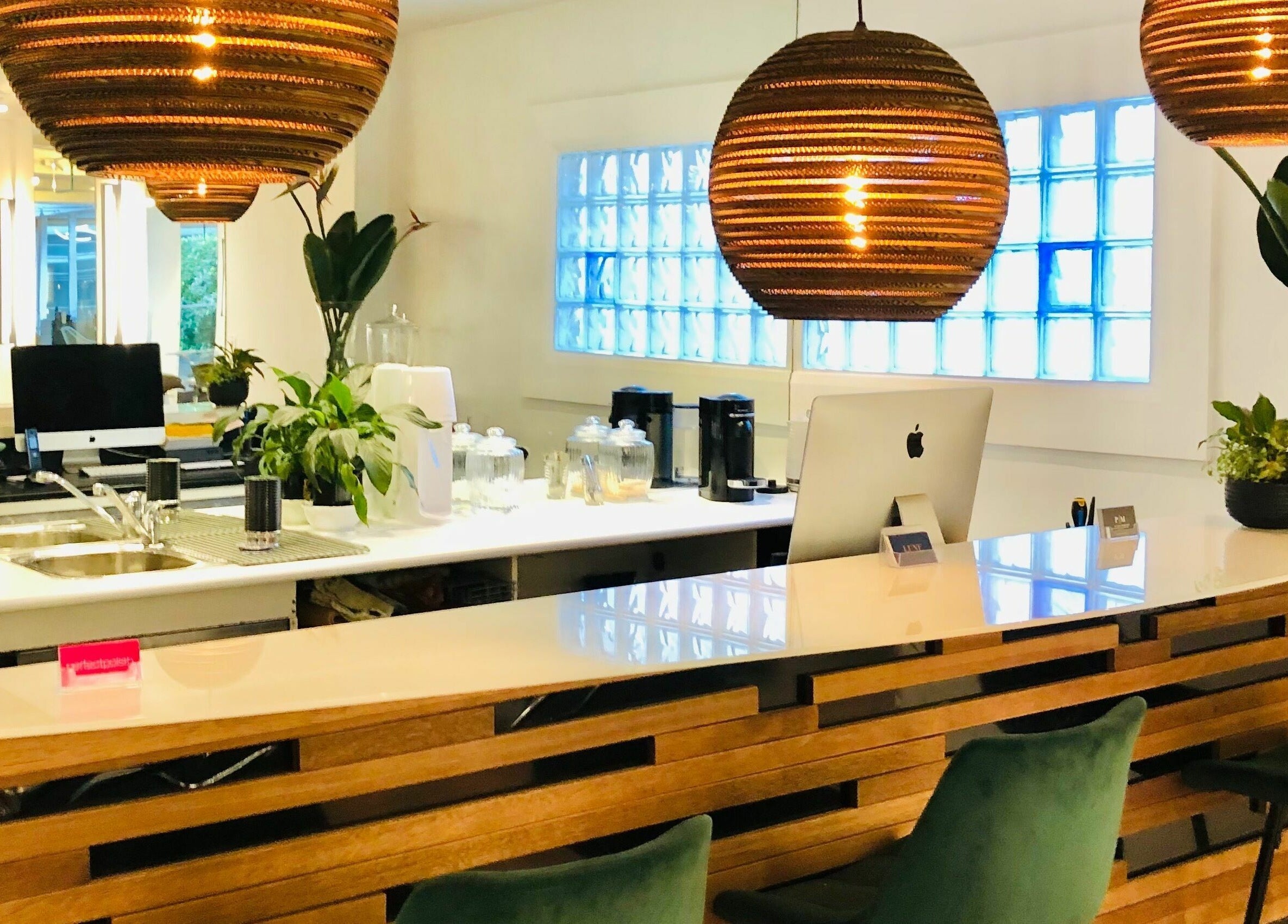 Stylish reception area at Prodigal Hairdressing, Toorak, Victoria, AU with modern decor and warm lighting.