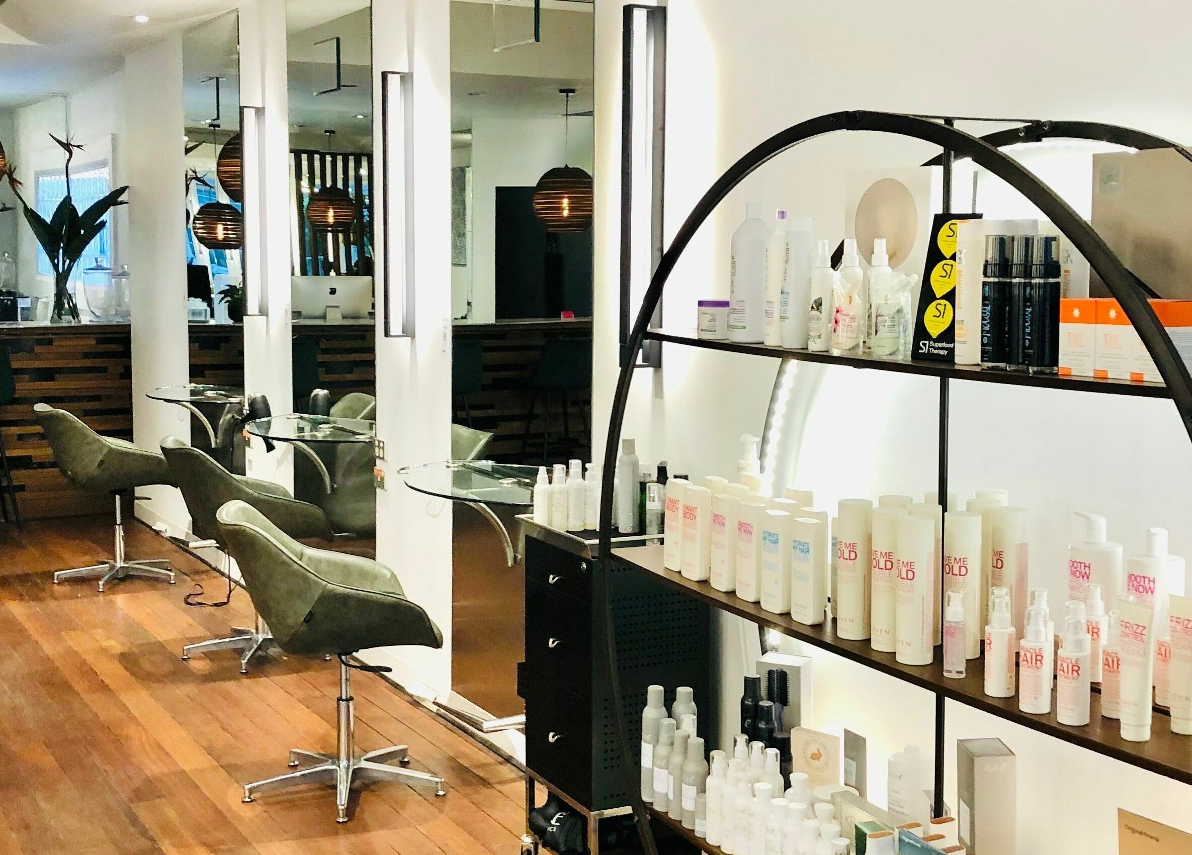 Elegant salon interior at Prodigal Hairdressing, Toorak, Victoria, AU showcasing chairs and hair products.