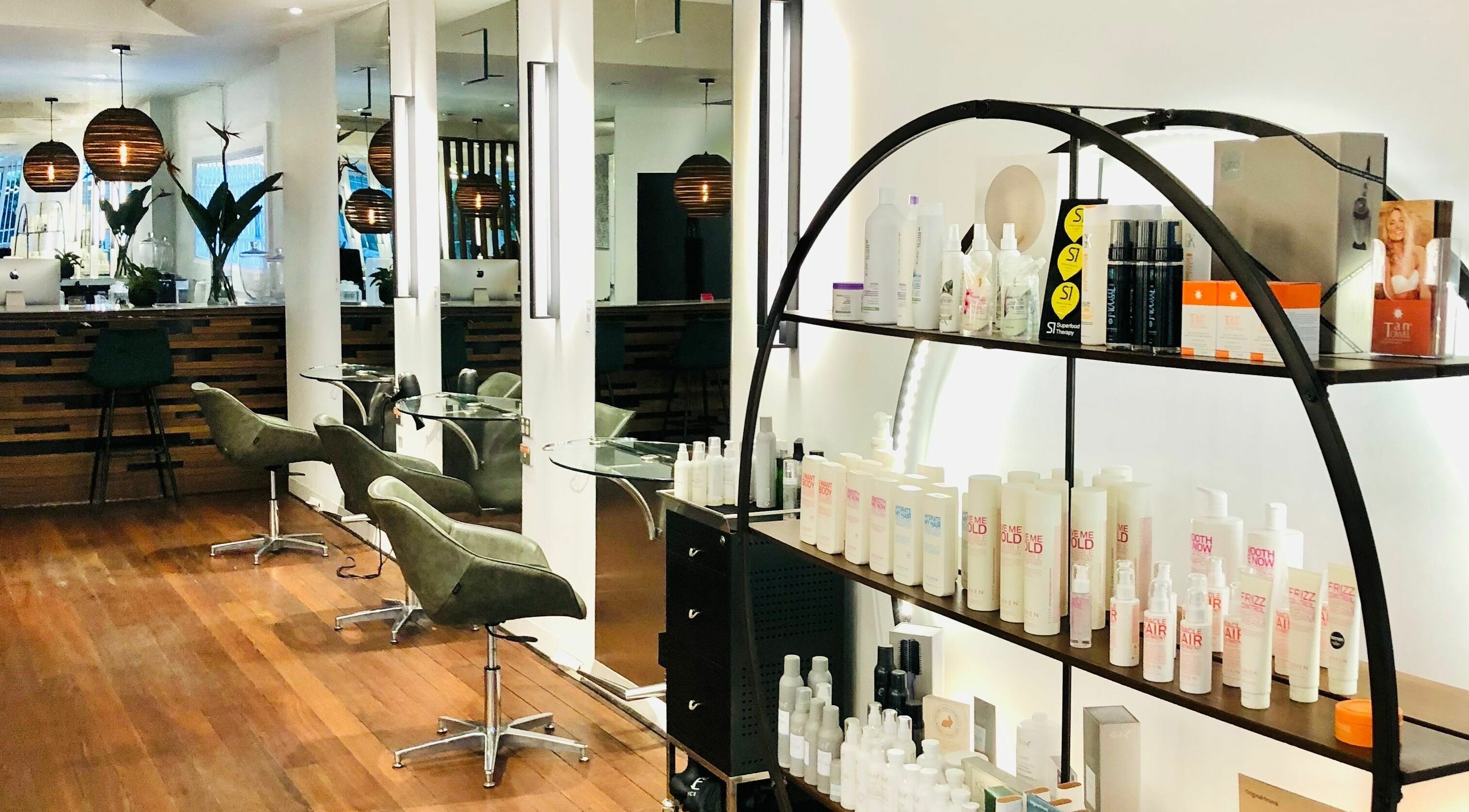 Elegant salon interior at Prodigal Hairdressing, Toorak, Victoria, AU showcasing chairs and hair products.