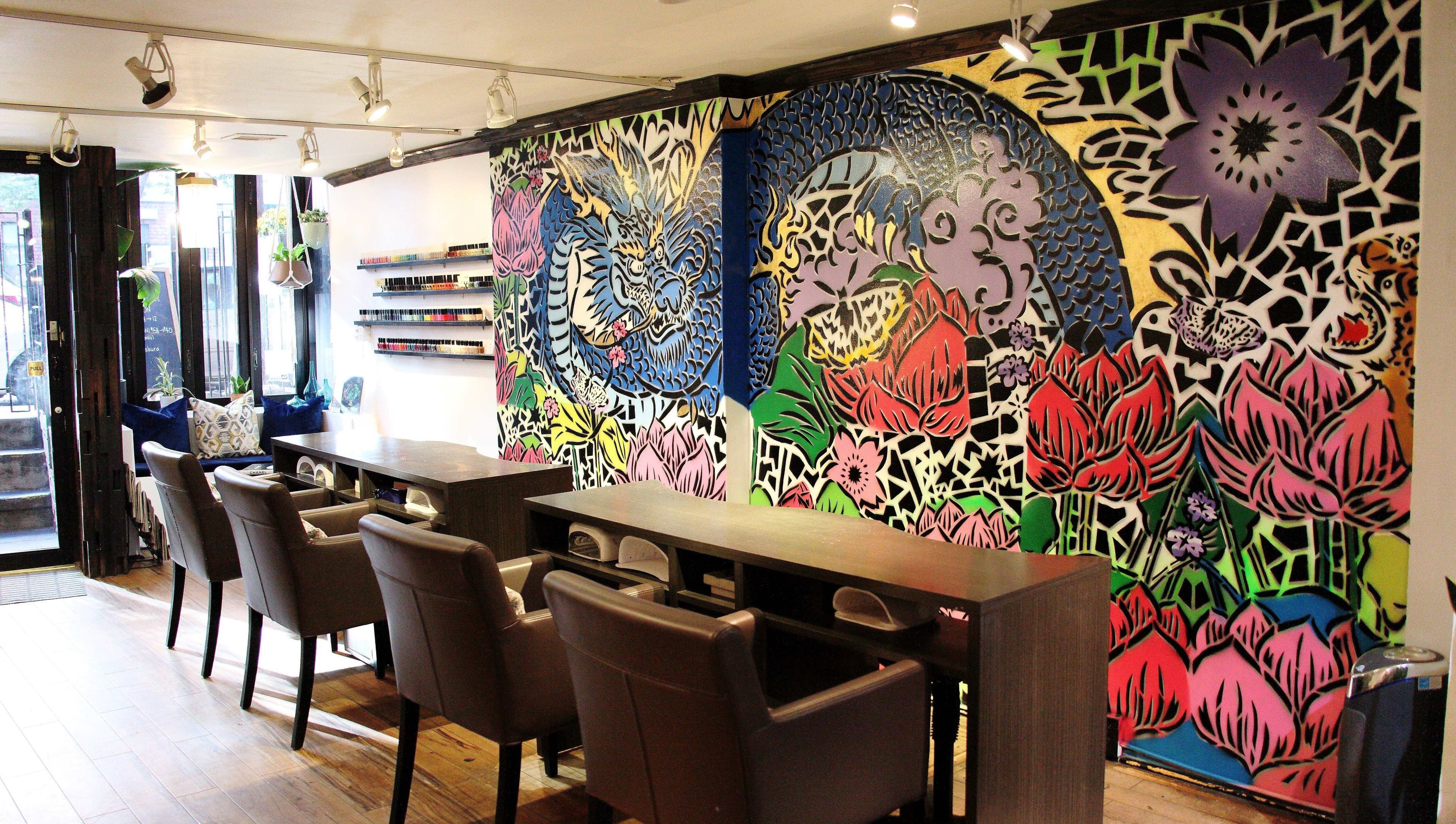 Vibrant, artistic interior of VIBLiSSiMO Art of Beauty in New York, US with colorful wall murals and manicure stations.