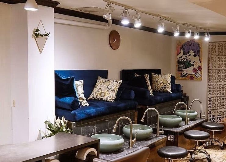 Elegantly designed pedicure area at VIBLiSSiMO Art of Beauty, New York, New York, US with plush seating and modern decor.