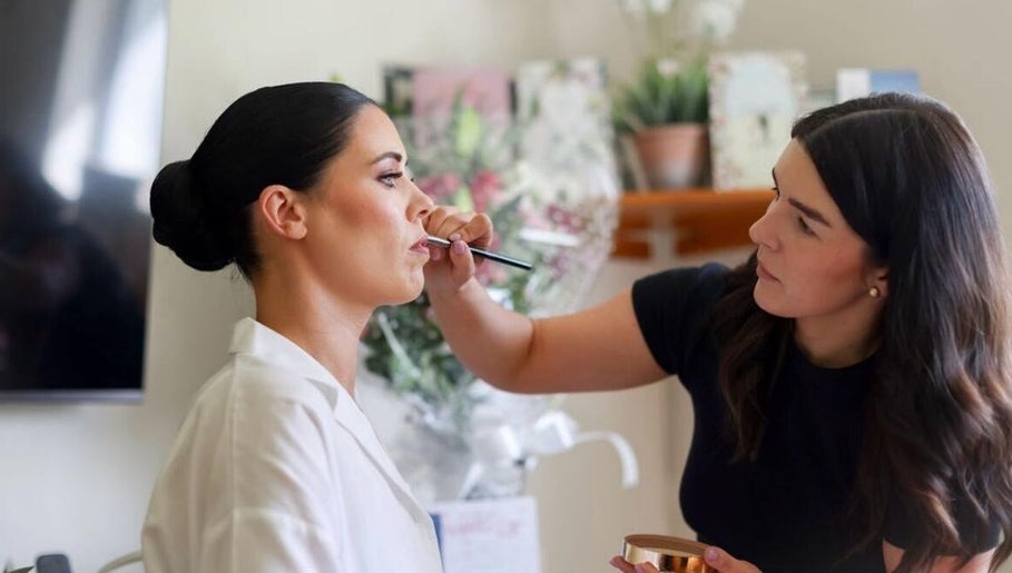 Makeup artist at Katie Wrynne Makeup & Beauty in County Galway, IE, applying lipstick.