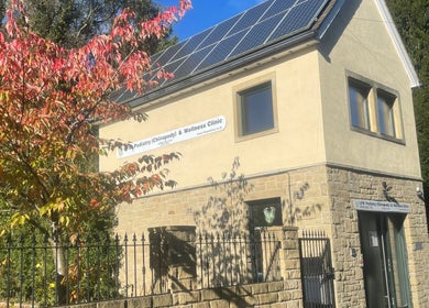 LFW Podiatry Clinic in Ilkley with solar panels and autumn foliage.