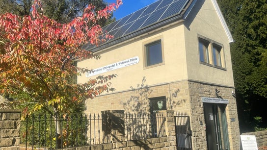 LFW Podiatry Clinic in Ilkley with solar panels and autumn foliage.