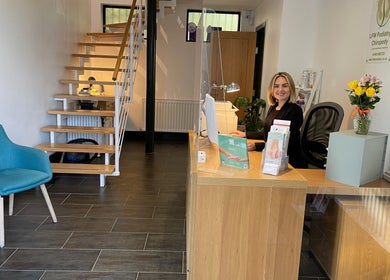 Reception area of LFW Podiatry (Chiropody) Clinic - Ilkley, featuring a smiling staff member and modern decor in Ilkley, GB.