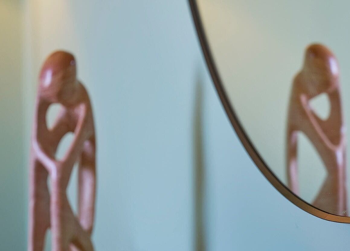 Stylish sculpture reflected in a mirror at Thrive Therapies, Bideford, England, GB.
