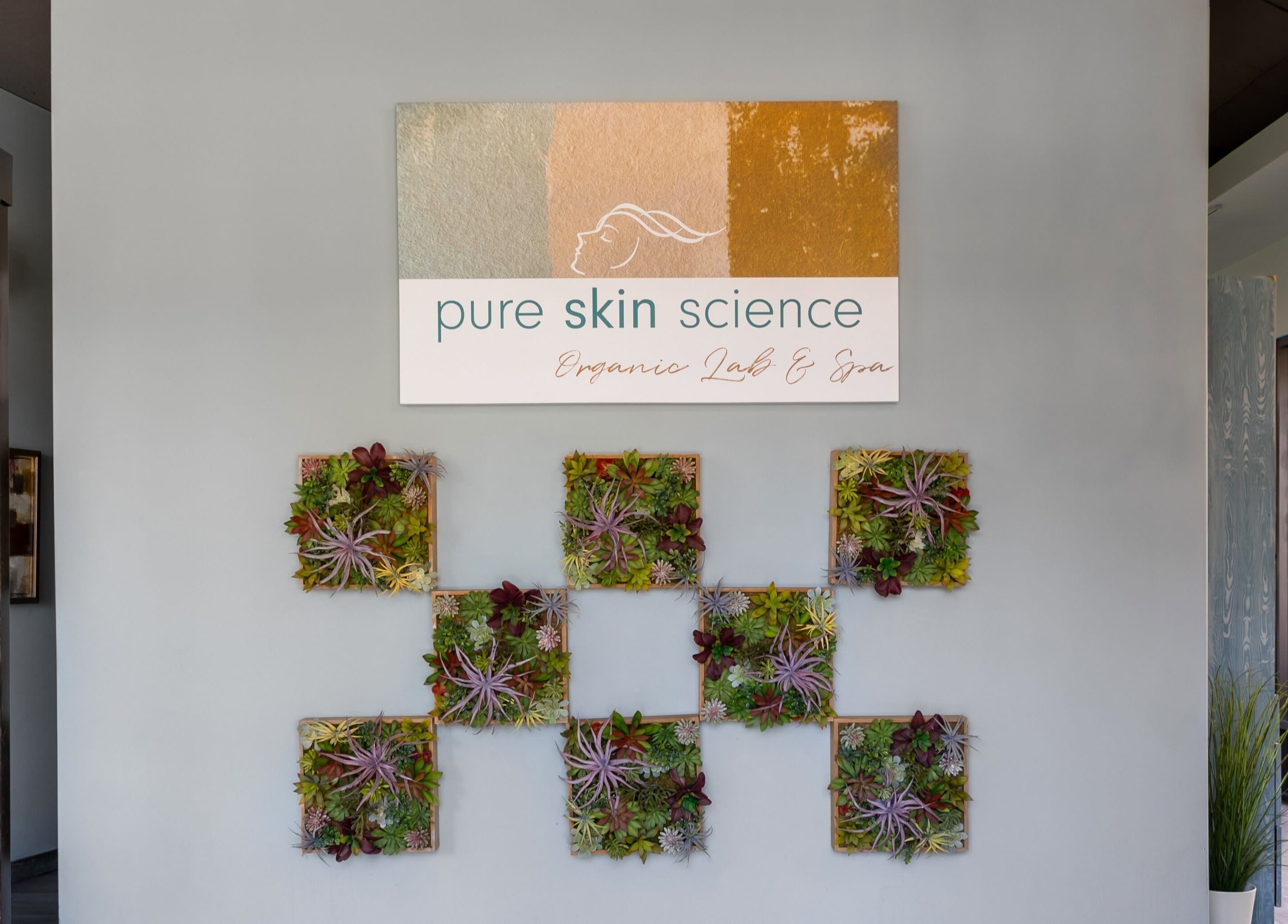 Entrance wall of Pure Skin Science Organic Lab and Spa, San Clemente, California, US, adorned with lush plants.