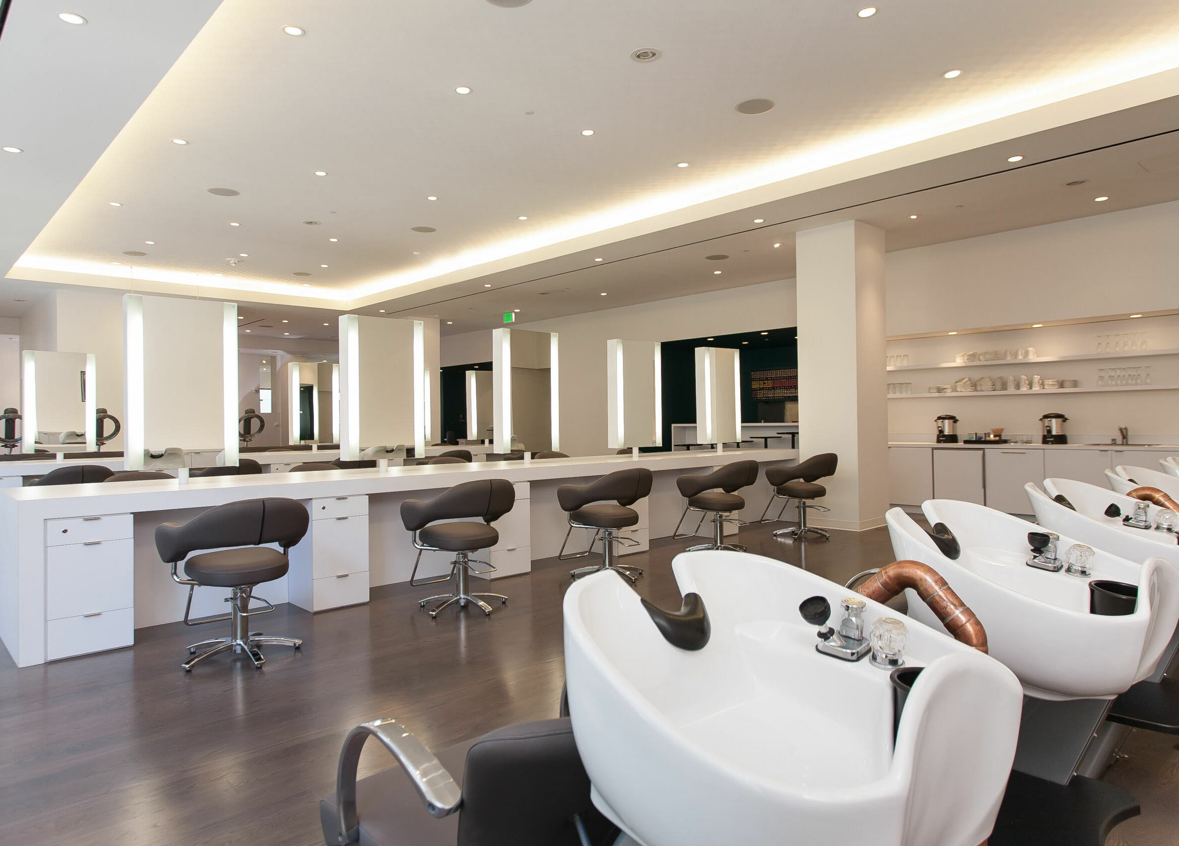 Modern interior of Angela Chong-Montague (J. Roland Salon) in San Francisco, California, US with sleek styling stations.