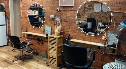 Warm salon interior at JLC Couture Artistry, Werrington, New South Wales, AU featuring stylish seating and mirrors.
