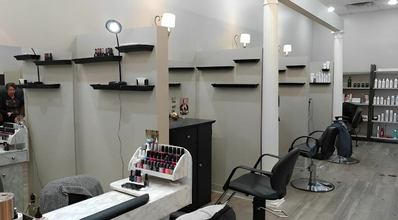 Stylish and modern salon at Prim. in Rockford, Illinois, US, featuring sleek chairs and beauty shelves.