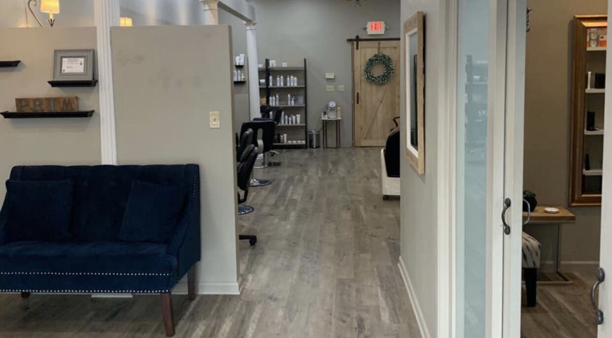 Chic salon interior at Polished in Rockford, Illinois, US, showcasing modern decor and styling stations.