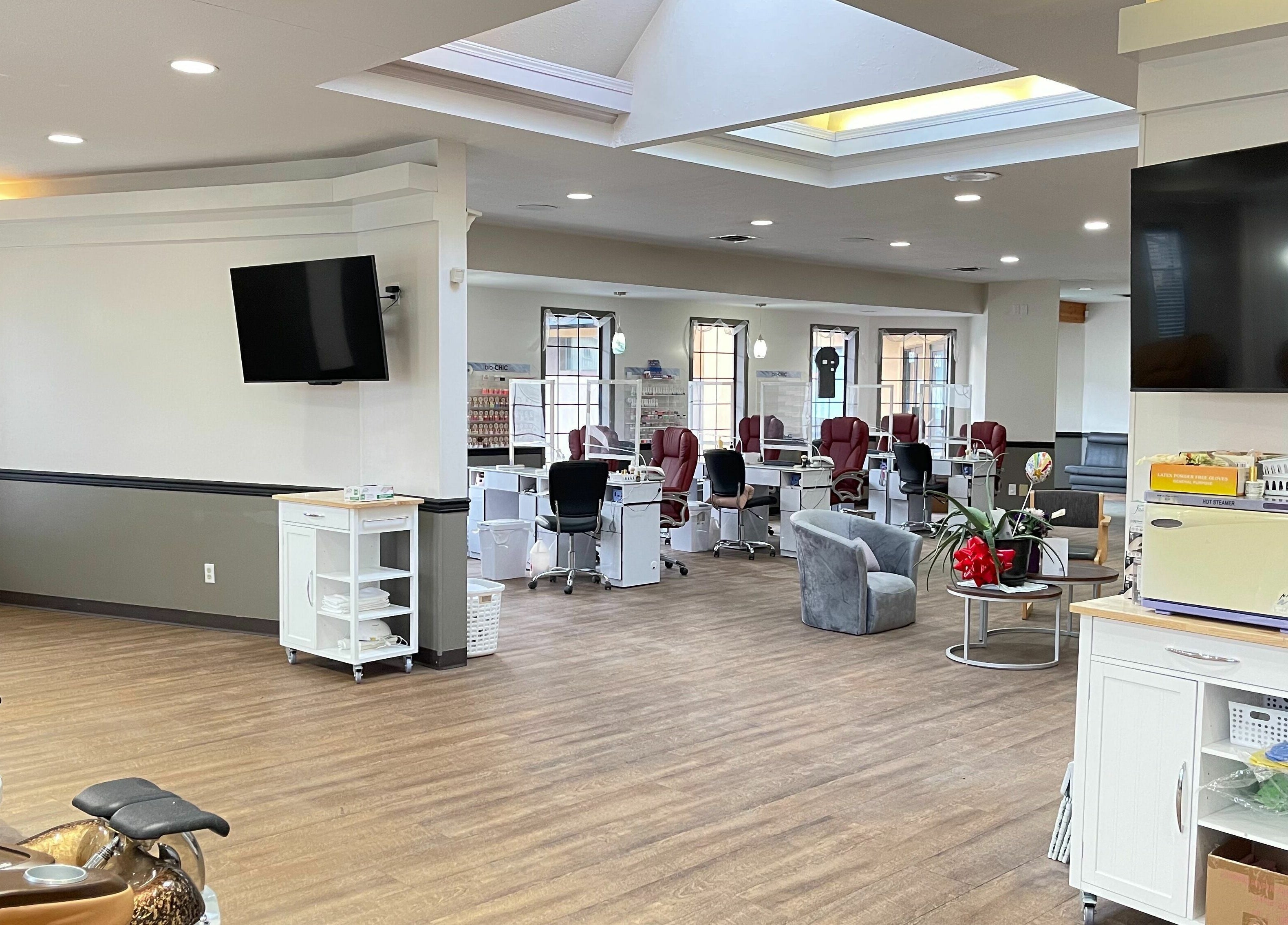 Spacious interior of Osoyoos Nail Studio in Osoyoos, British Columbia, CA with nail stations and cozy seating.
