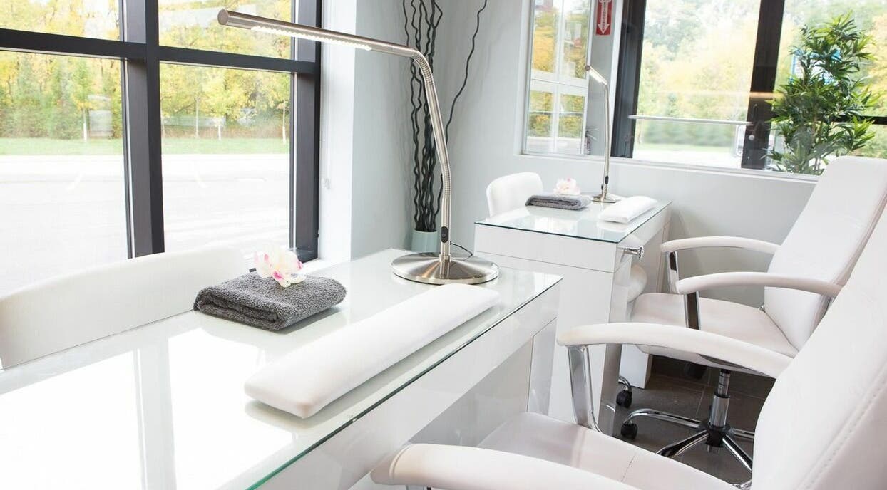 Elegant nail station at CedarHouse Spa in Mississauga, Ontario, CA, featuring sleek white chairs and a calming ambiance.