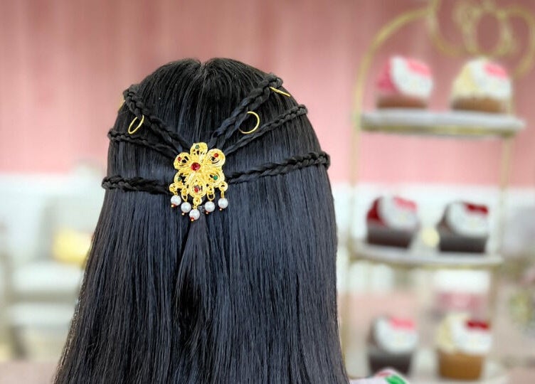 Ornate hairstyle with gold accessory at Hello Kitty Beauty Spa Dubai, Dubai, AE.