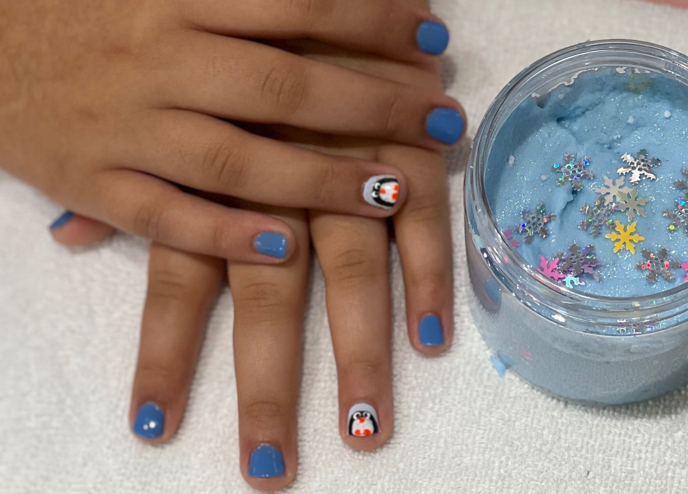 Blue manicure with penguin art at Hello Kitty Beauty Spa Dubai, Dubai, AE.