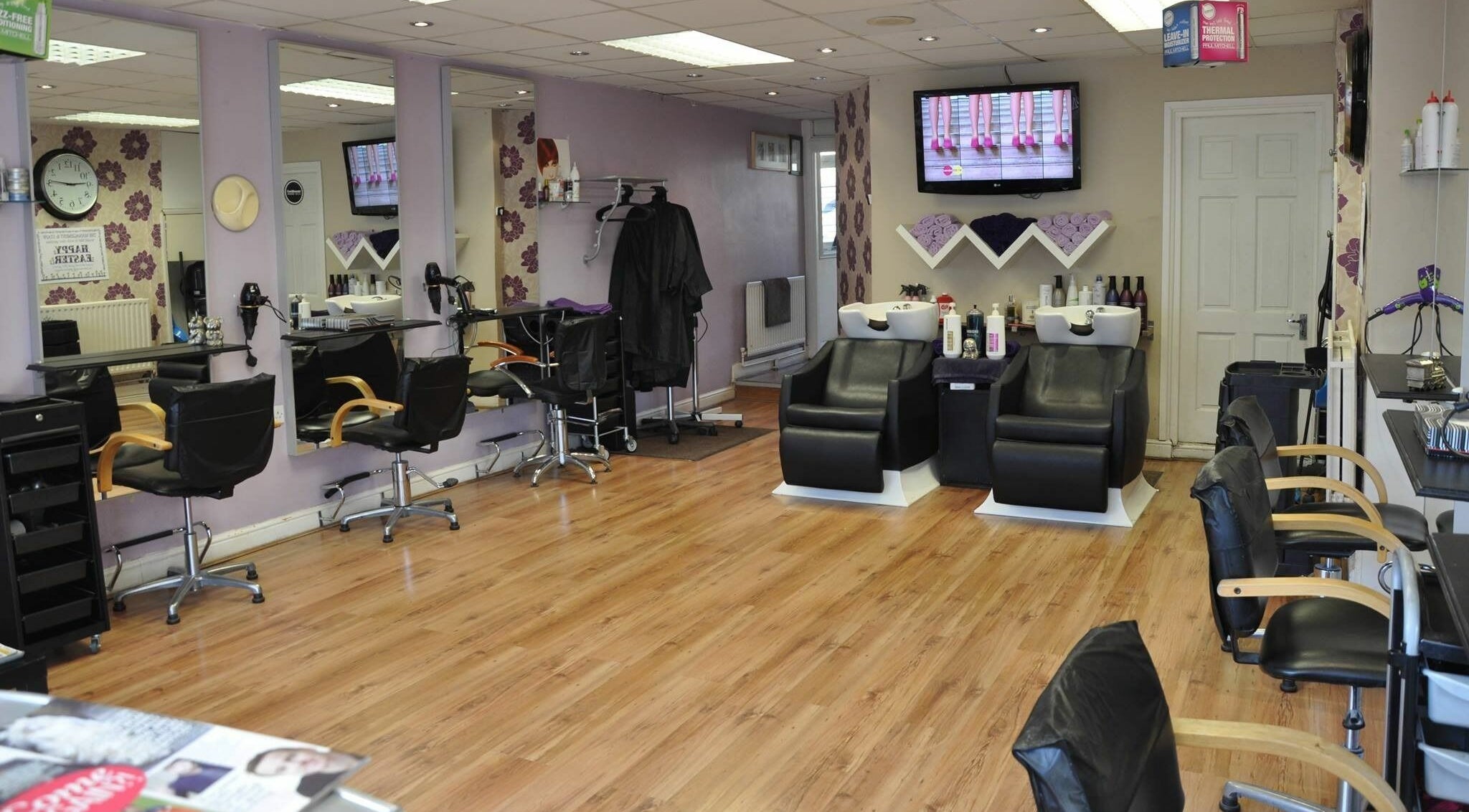 Spacious styling stations at Emrah Hairdressing in London, England, GB with modern decor and sleek chairs.