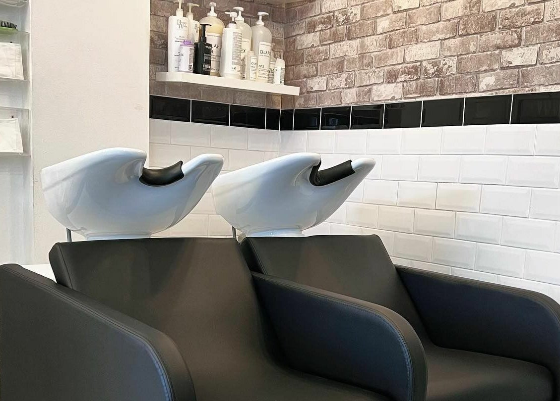 Modern wash stations at The Hair Company in Codsall, England, GB, featuring sleek design and comfort.