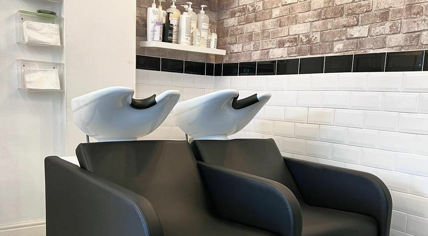 Modern wash stations at The Hair Company in Codsall, England, GB, featuring sleek design and comfort.
