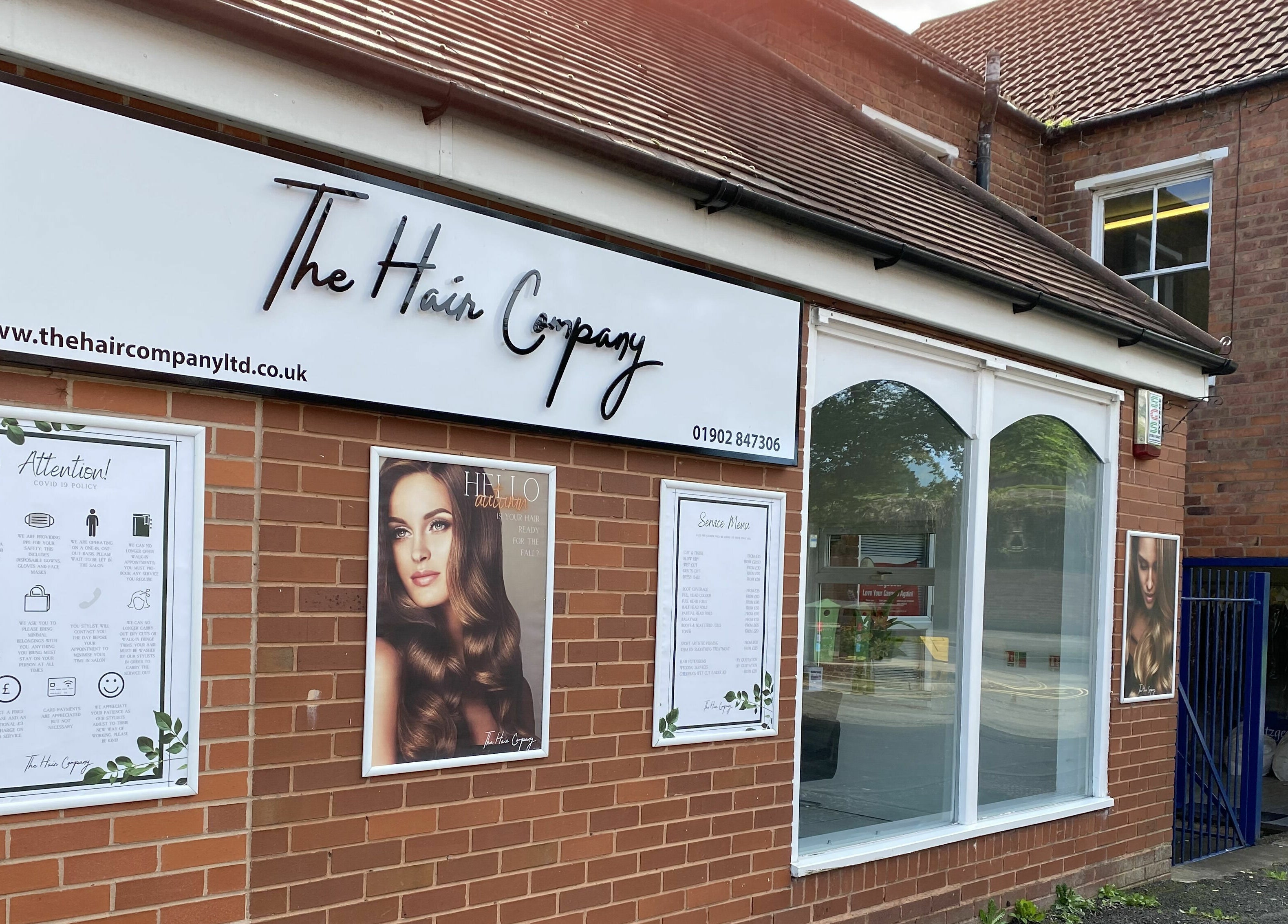 Front view of The Hair Company salon in Codsall, England, showcasing stylish signage and inviting entrance.