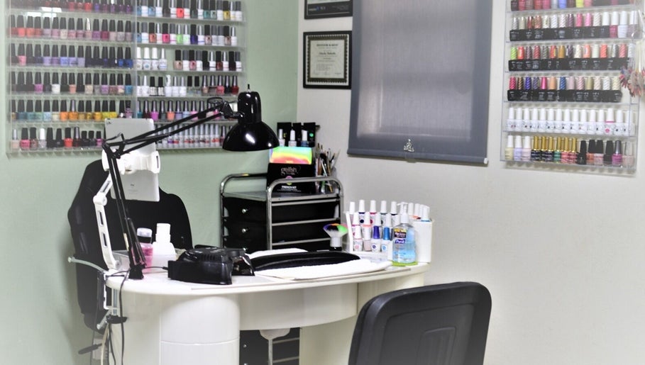 Nash Nails and Skin Care Services in Barbados, Saint George, BB showcases a vibrant nail polish display wall.