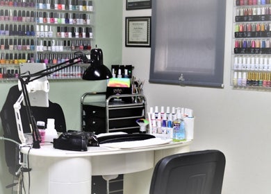 Nash Nails and Skin Care Services in Barbados, Saint George, BB showcases a vibrant nail polish display wall.