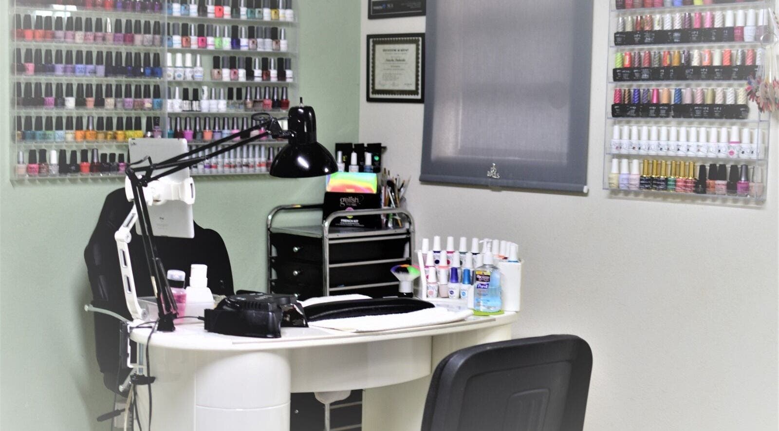 Nash Nails and Skin Care Services in Barbados, Saint George, BB showcases a vibrant nail polish display wall.