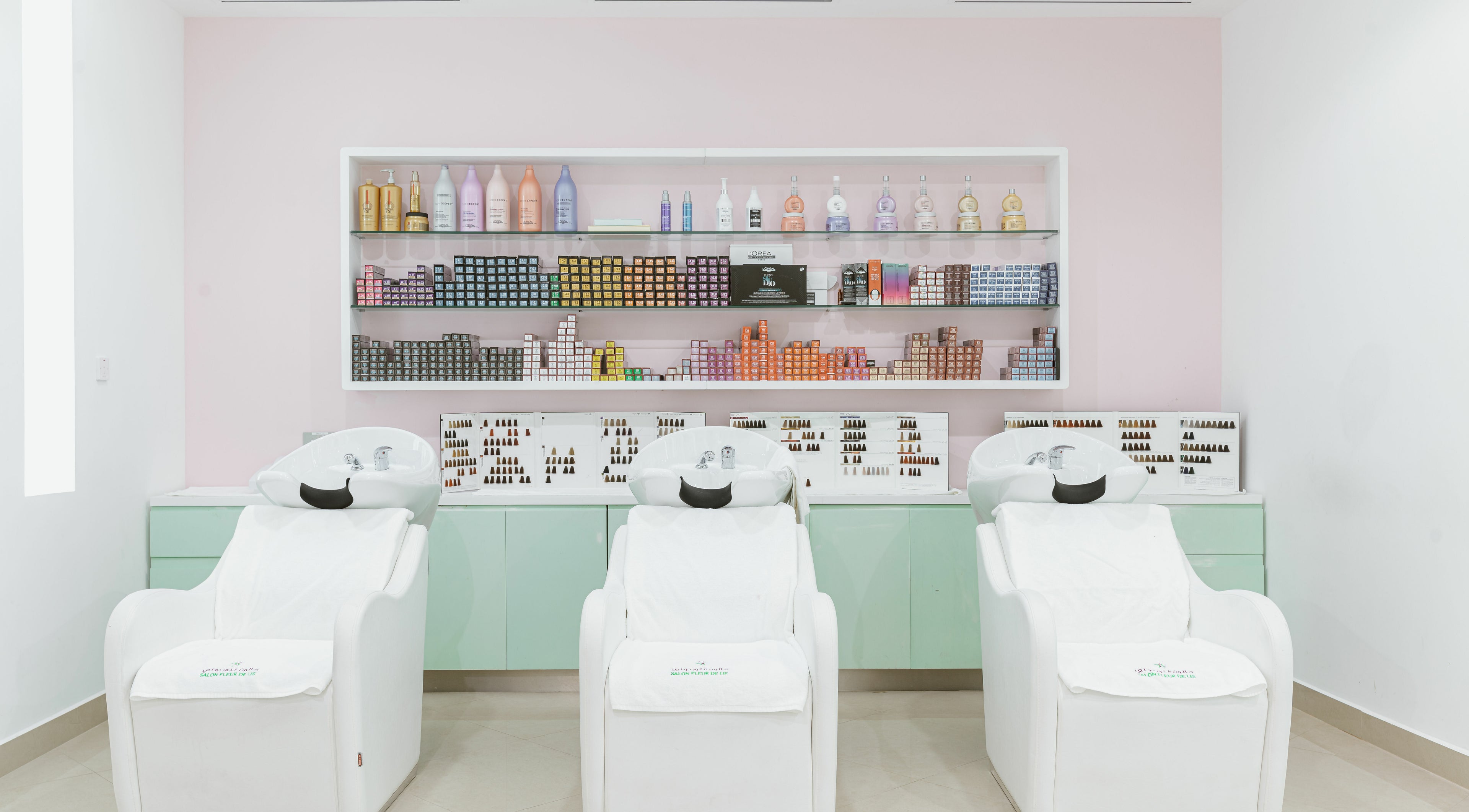 Elegant salon chairs and colorful products at Salon Fleur De Lis - Mirqab Mall المرقاب مول, Doha, Doha, QA.