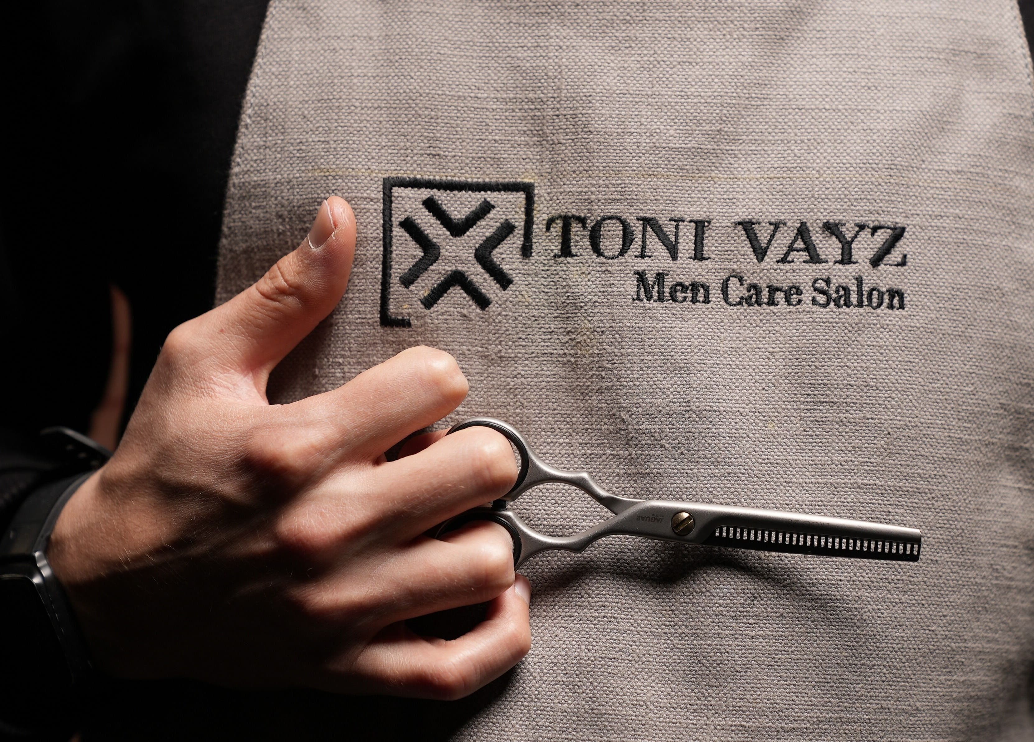 Barber holding scissors at Toni Vayz | Men | Alkhobar Alshubaily, Ansab Plaza, SA.