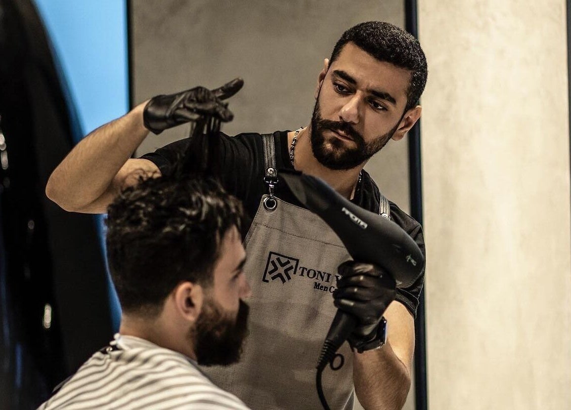 Professional haircut at Toni Vayz | Men | Alkhobar Alshubaily, Ansab Plaza, SA with skilled barber using a dryer.
