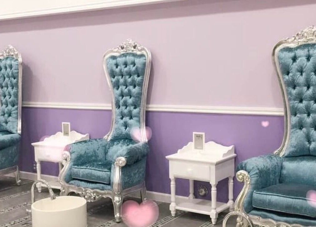 Elegant seating area at Le Muse Beauty, San Gabriel, California, US with plush blue chairs.