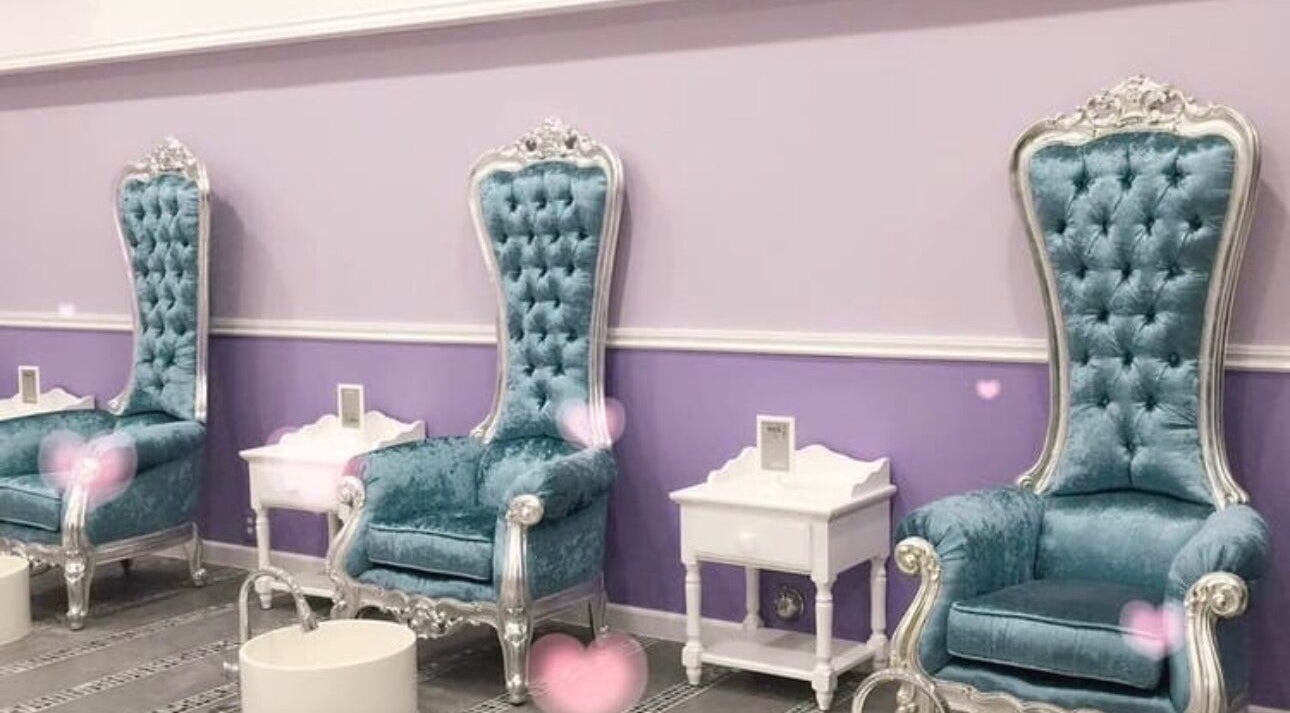 Elegant seating area at Le Muse Beauty, San Gabriel, California, US with plush blue chairs.