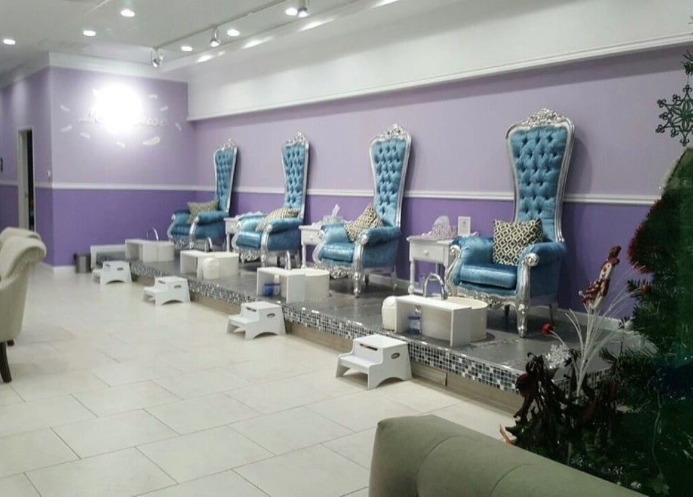 Elegant pedicure chairs at Le Muse Beauty in San Gabriel, California, US, showcasing plush blue seating.