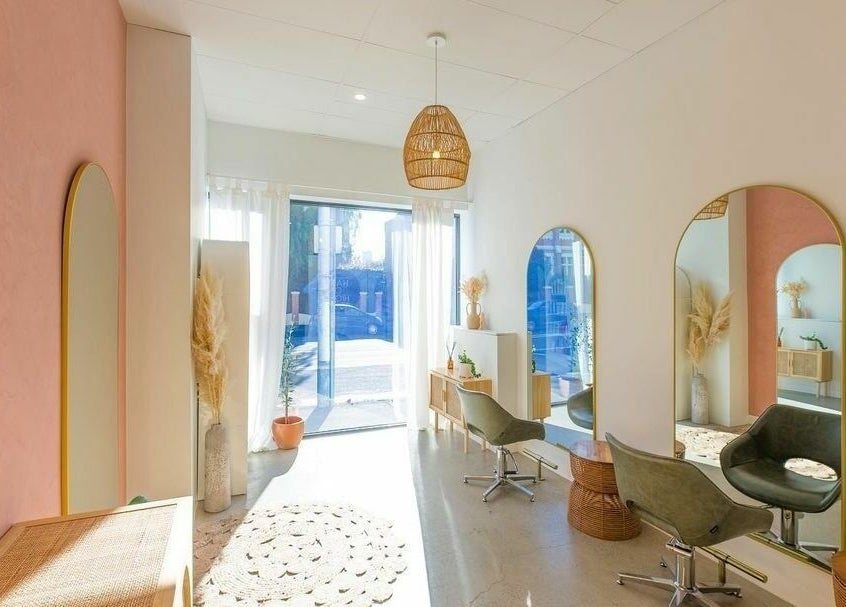 Elegant salon interior at HAIR ON HIGH, Melbourne, Victoria, AU with modern chairs and mirrors.
