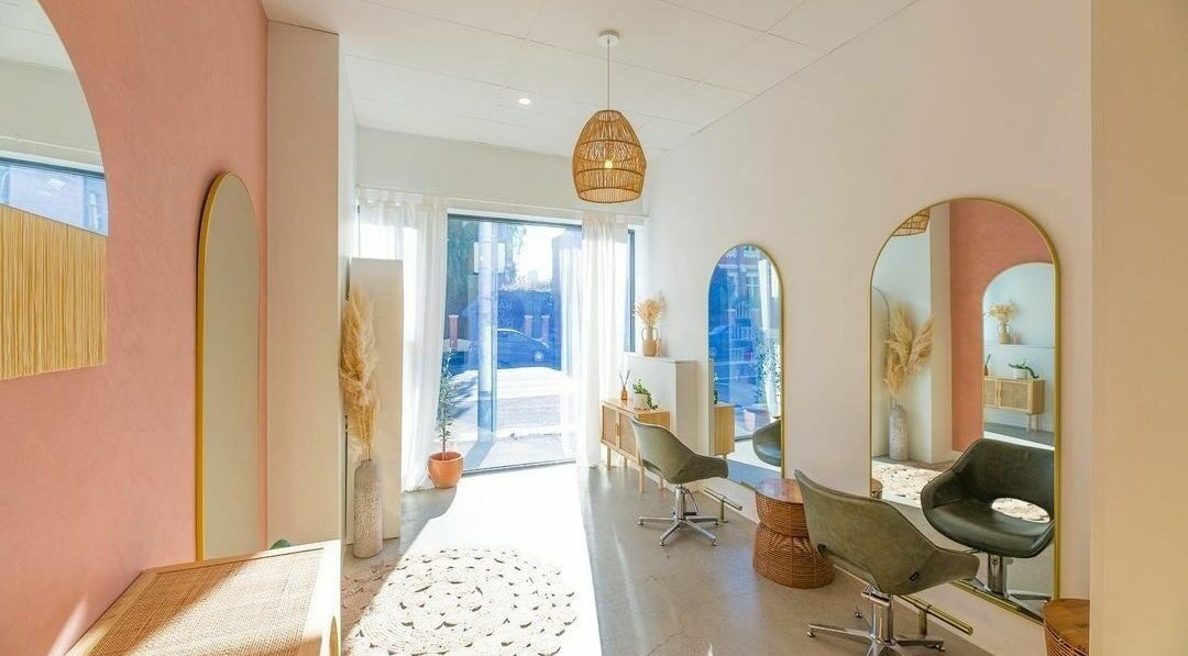 Elegant salon interior at HAIR ON HIGH, Melbourne, Victoria, AU with modern chairs and mirrors.
