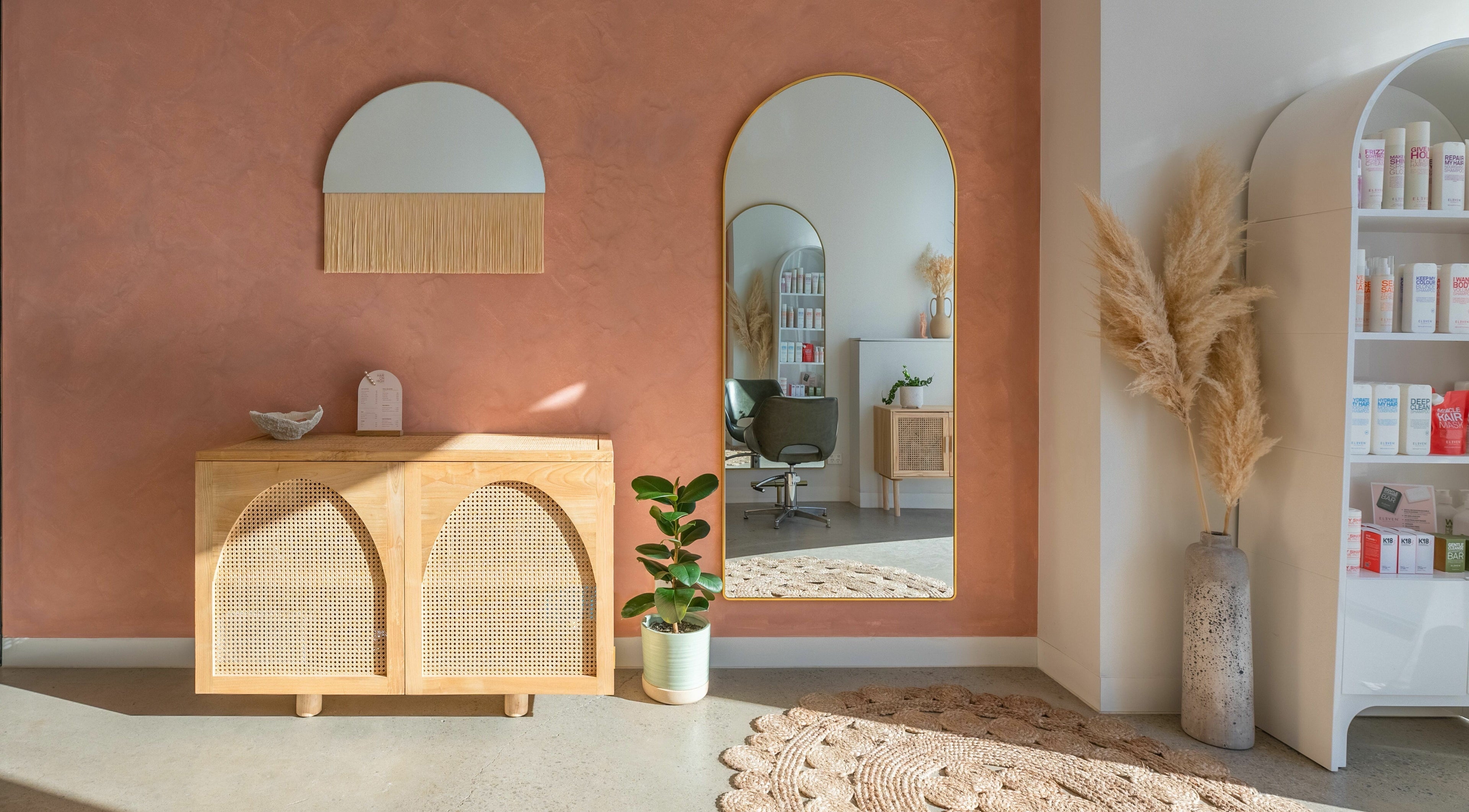 Elegant salon interior at HAIR ON HIGH, Melbourne, Victoria, AU featuring warm tones and modern decor.