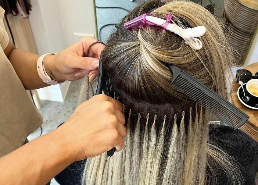 Hair extensions in process at HAIR ON HIGH, Melbourne, Victoria, AU, showcasing professional styling expertise.