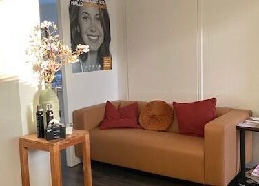 Gezellige loungeruimte bij Mooi en Zeker, Amersfoort, Utrecht, NL met comfortabele bank en decoratie.