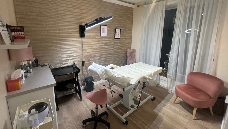 Beauty Within treatment room in Cheadle, England, GB with modern decor and comfortable seating.