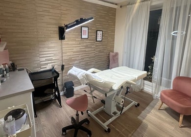 Beauty Within treatment room in Cheadle, England, GB with modern decor and comfortable seating.