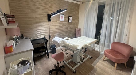 Beauty Within treatment room in Cheadle, England, GB with modern decor and comfortable seating.