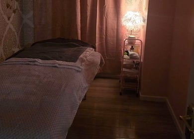 Relaxing massage room at Beauty Within, Cheadle, England, GB with soft lighting and cozy decor.