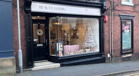 Exterior of Beauty Within in Cheadle, England, adorned with festive decorations and elegant signage.