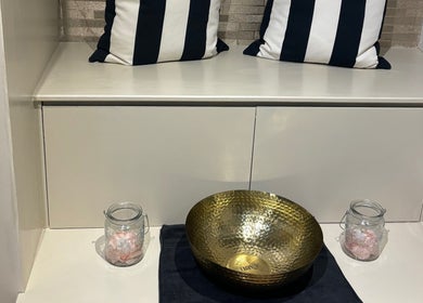 Elegant relaxation area at Beauty Within, Cheadle, England, GB, featuring chic seating and a decorative bowl.