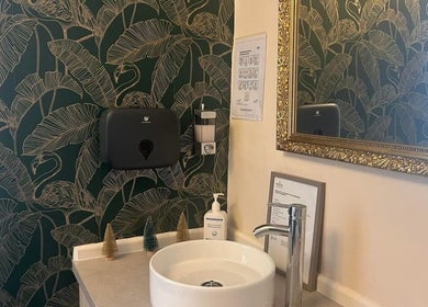 Elegant vanity with floral wallpaper at Beauty Within, Cheadle, England, GB.