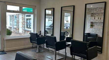 Modern salon interior at Salon in the Square, Mawnan Smith, England, GB with stylish chairs and mirrors.