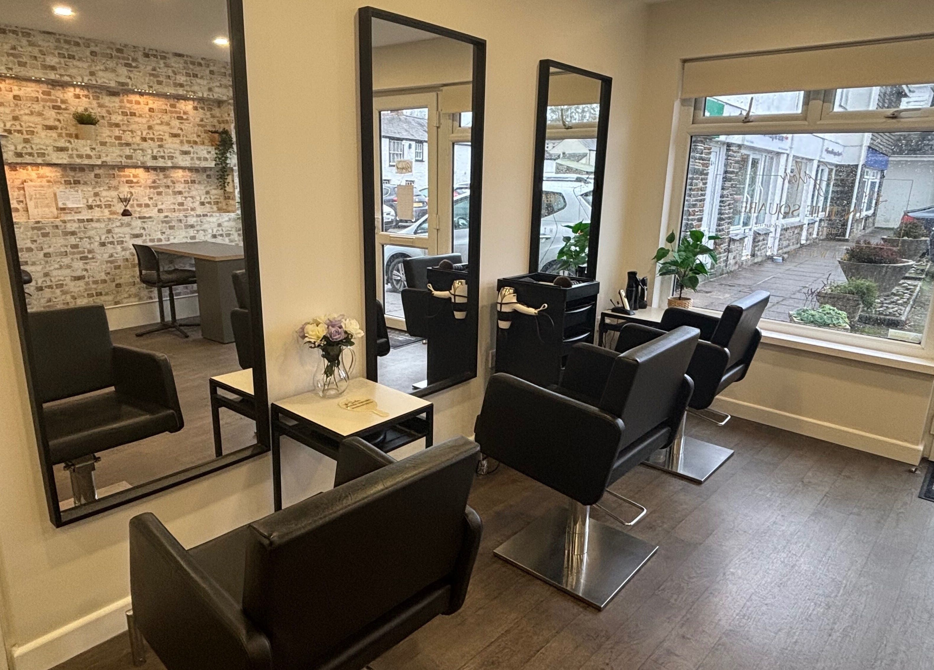 Modern interior of Salon In The Square, Mawnan Smith, England, GB with stylish mirrors and seats.