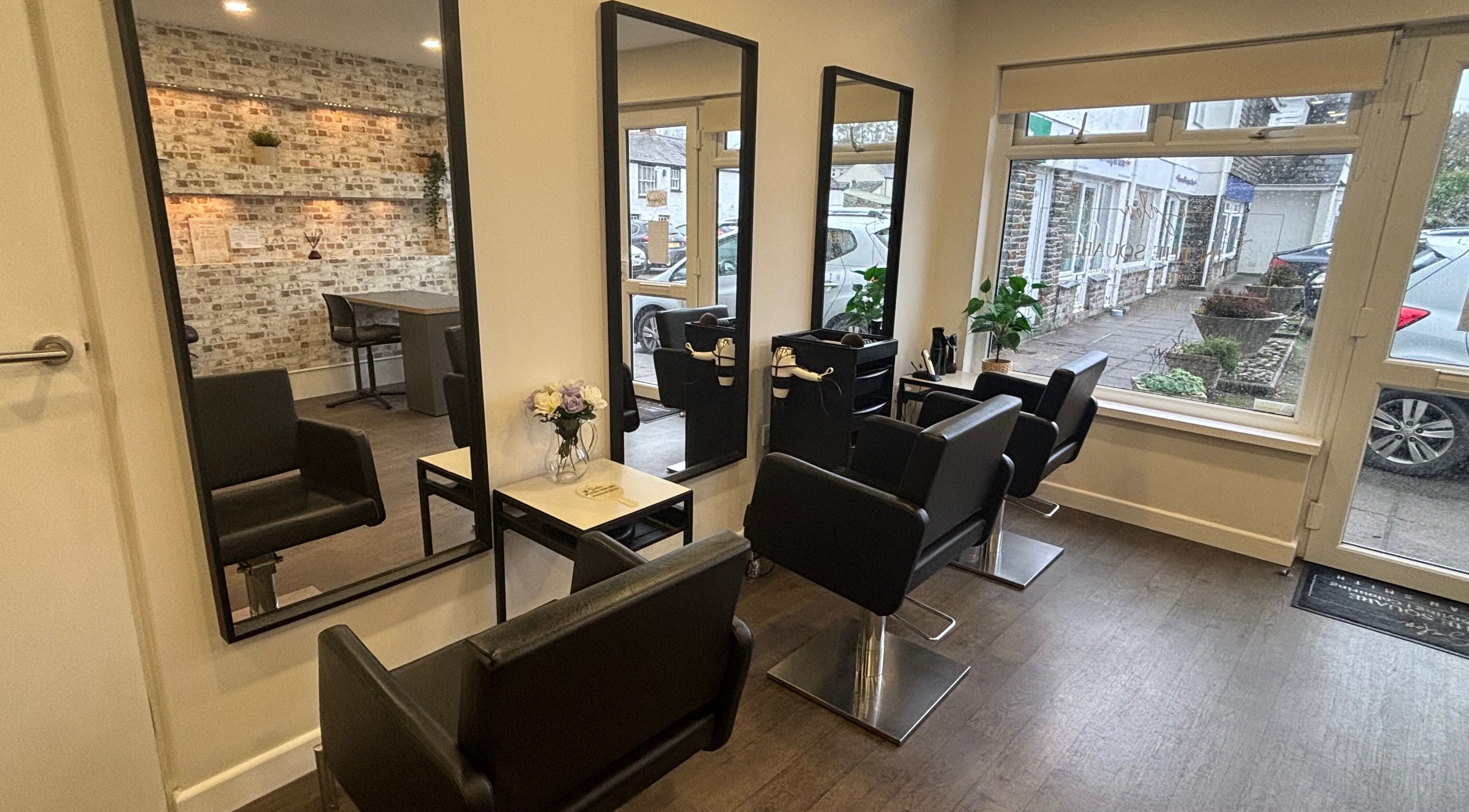 Modern interior of Salon In The Square, Mawnan Smith, England, GB with stylish mirrors and seats.